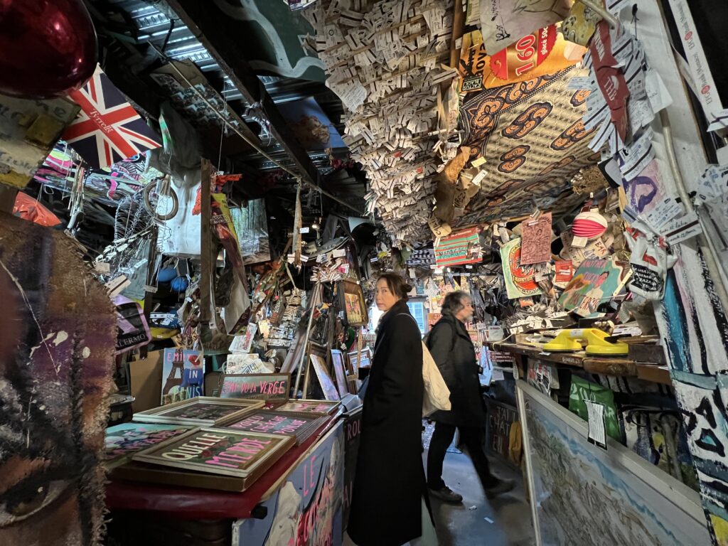 Interior view of 59 Rivoli in Paris, showing artists working in a vibrant and eclectic space filled with colorful artwork and creative energy.