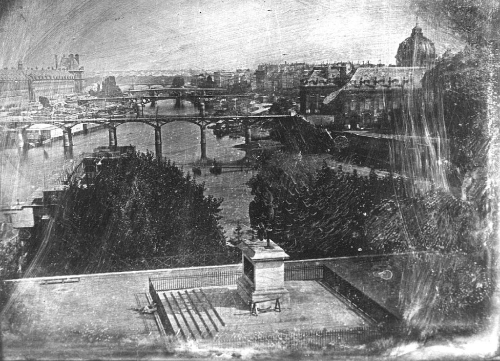 An early photograph by Louis Daguerre showing workers resting on Pont Neuf, considered among the first images to include human beings.