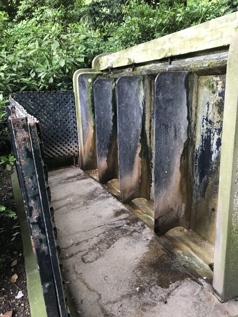 Photo of the public urinal in the Luxembourg Gardens, showcasing Paris's blend of practicality and tradition in one of its most cherished green spaces.