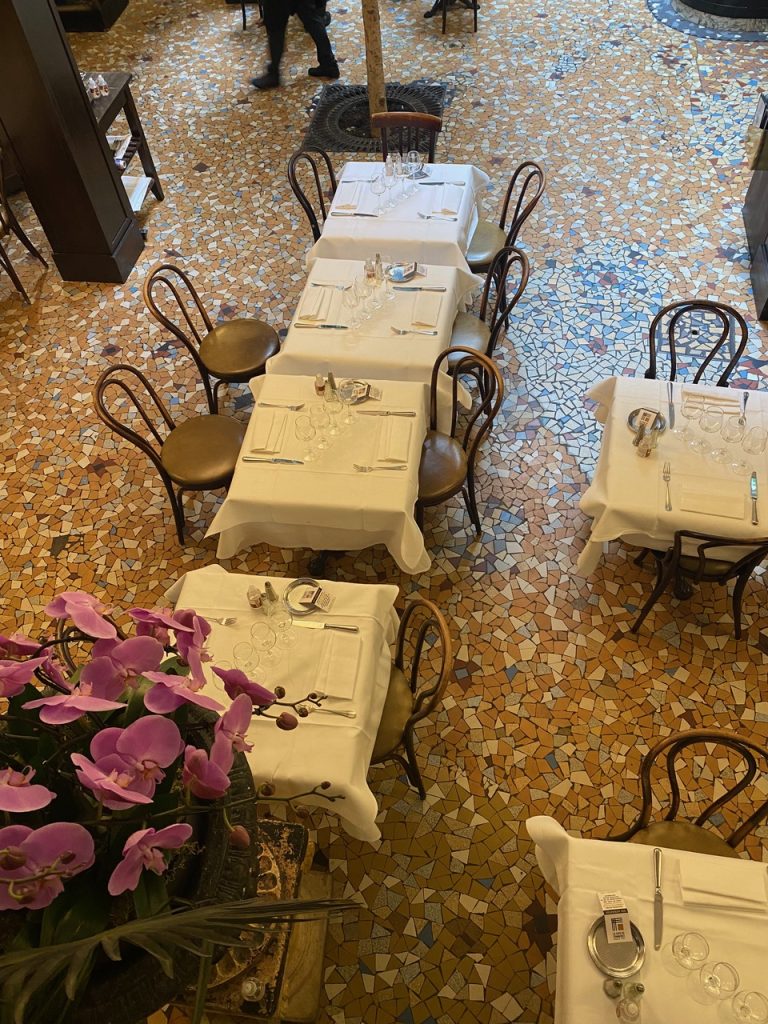 Close-up of the detailed mosaic floor at Café du Commerce in Paris, showcasing geometric patterns and vintage craftsmanship.