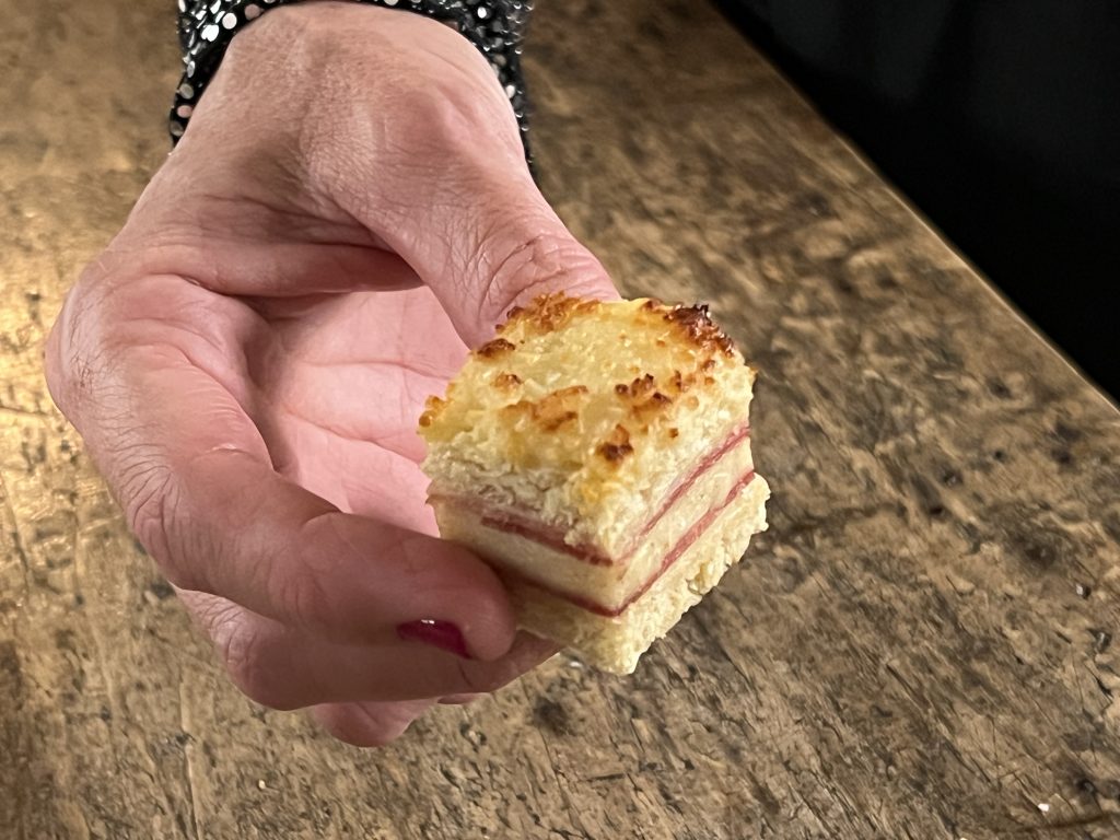 
Close-up of a croque monsieur canapé from Jeusselin Traiteur, showcasing its golden, crunchy top, creamy béchamel layer, and soft interior.