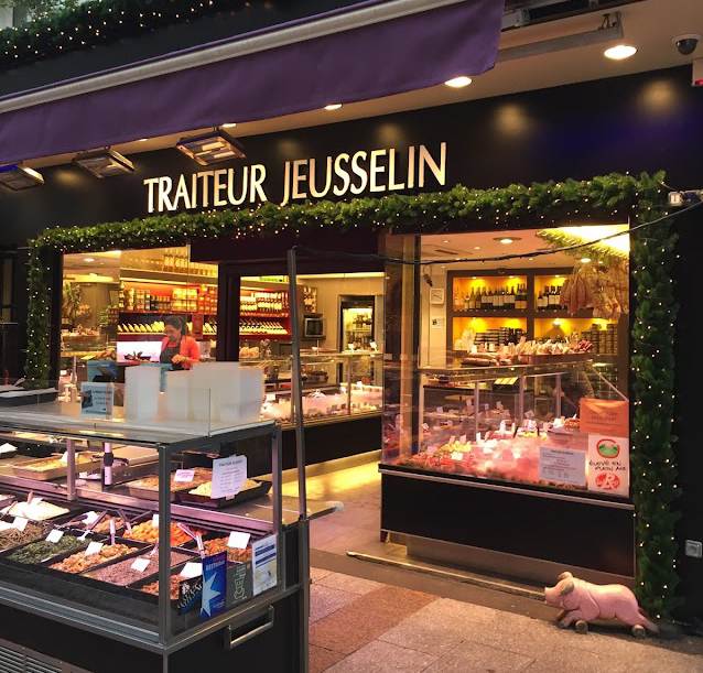 Exterior of Jeusselin Traiteur on Rue Cler, Paris, with its charming storefront and inviting display of artisanal delicacies.